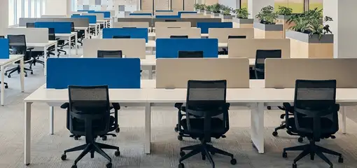 Modern open-plan office space featuring clean workstations, ergonomic chairs, and sanitized carpets provided by professional office cleaning services in Newark, NJ.