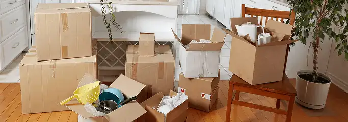 Packed moving boxes and household items in a kitchen before move-out or move-in cleaning, Newark, NJ.